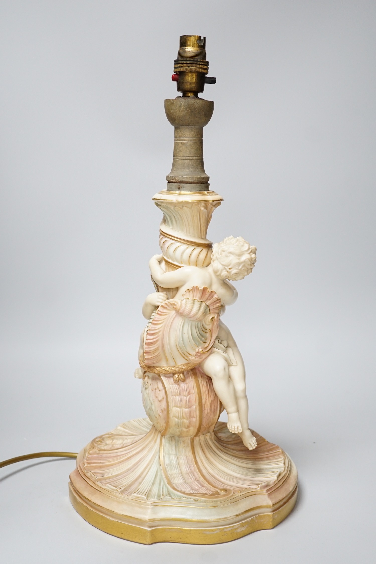 A large Royal Worcester blush ivory cherub lamp base, 40cm not including light fitting